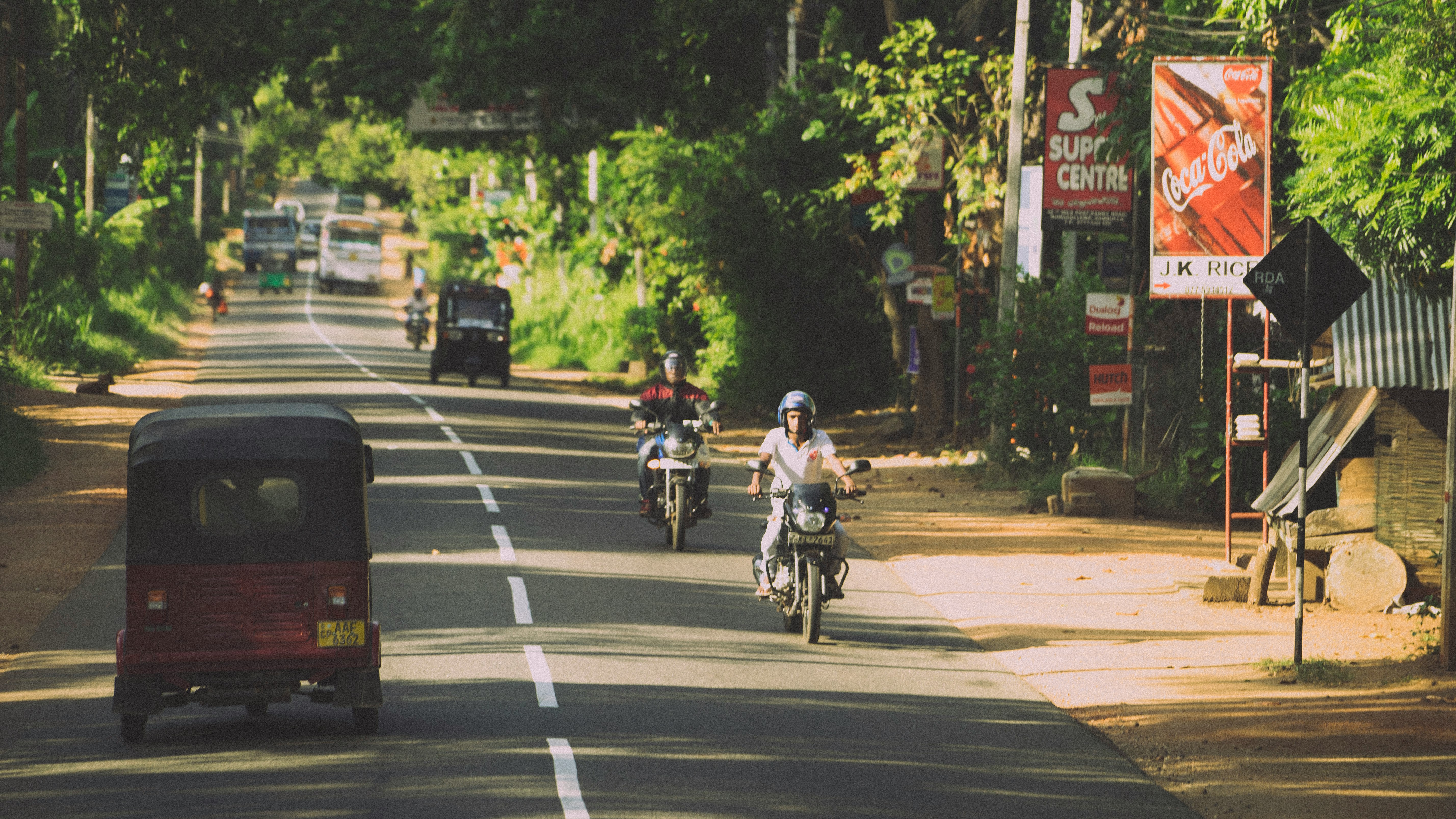 man in black jacket riding bicycle on road during daytime